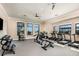 Community fitness center features modern exercise equipment, weights, and large windows with views of the neighborhood at 18068 Cherished Loop, Bradenton, FL 34211