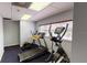 Well-lit exercise room featuring an elliptical machine, treadmill, and large bright window at 227 Central Ave, Sarasota, FL 34236