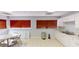 Bright kitchenette features white cabinets, tile flooring, and a double basin stainless steel sink beneath a large window at 227 Central Ave, Sarasota, FL 34236