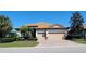 Charming single-story home with a tile roof, brick paver driveway and well-manicured landscaping at 227 Heritage Preserve Run, Bradenton, FL 34212