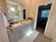 Well-lit bathroom with a double sink vanity, granite countertops, and glass enclosed shower at 43819 Cattleman Dr, Punta Gorda, FL 33982