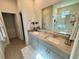 Bathroom featuring a double sink vanity with granite countertop and a glass-enclosed shower at 43819 Cattleman Dr, Punta Gorda, FL 33982