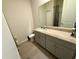 Bathroom featuring a granite vanity top, neutral color palette, and a large mirror at 43819 Cattleman Dr, Punta Gorda, FL 33982