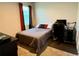 Bedroom featuring neutral color palette, a bed with a patterned quilt, and a desk at 43819 Cattleman Dr, Punta Gorda, FL 33982