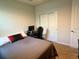 Bedroom featuring neutral color palette, a bed with a patterned quilt, and a desk at 43819 Cattleman Dr, Punta Gorda, FL 33982