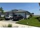 Charming single-story home with a two-car garage, paved driveway, and well-maintained landscaping at 43819 Cattleman Dr, Punta Gorda, FL 33982