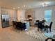 Open-concept kitchen with stainless steel appliances, a large island, and a dining area at 43819 Cattleman Dr, Punta Gorda, FL 33982