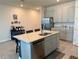 Well-lit kitchen featuring a center island with seating, stainless steel appliances, and ample cabinetry at 43819 Cattleman Dr, Punta Gorda, FL 33982