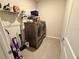 Convenient laundry room with modern washer and dryer set, plus overhead storage at 43819 Cattleman Dr, Punta Gorda, FL 33982