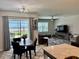 Open-concept living space features a dining area, and a spacious living room with natural light at 43819 Cattleman Dr, Punta Gorda, FL 33982