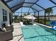 Relaxing screened-in pool area with chairs, umbrella, and outdoor seating for entertainment at 43819 Cattleman Dr, Punta Gorda, FL 33982