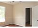 This bedroom has a window, neutral paint, chair rail and an open door at 5613 Legacy Crescent Pl # 201, Riverview, FL 33578