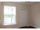 This bright bedroom has a window and a closet with bi-fold doors at 5613 Legacy Crescent Pl # 201, Riverview, FL 33578