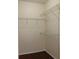 Walk-in closet with shelving for optimal storage, complemented by rich wood-look flooring at 5613 Legacy Crescent Pl # 201, Riverview, FL 33578