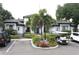 Community clubhouse with well-manicured landscaping, ample parking, and golf cart parking at 5613 Legacy Crescent Pl # 201, Riverview, FL 33578