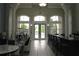 Spacious clubhouse with seating and bar overlooking the pool and manicured grounds at 5613 Legacy Crescent Pl # 201, Riverview, FL 33578