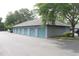 Row of detached garages with blue doors, offering convenient parking for residents at 5613 Legacy Crescent Pl # 201, Riverview, FL 33578