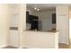 This kitchen has dark wood cabinets, an eat-in bar and track lighting at 5613 Legacy Crescent Pl # 201, Riverview, FL 33578