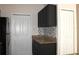 Kitchen featuring dark cabinets, granite countertops, stainless steel appliances, and white doors at 5613 Legacy Crescent Pl # 201, Riverview, FL 33578