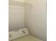 Clean laundry room features shelving above the washer and dryer and neutral paint at 5613 Legacy Crescent Pl # 201, Riverview, FL 33578