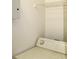 Clean laundry room features shelving above the washer and dryer and neutral paint at 5613 Legacy Crescent Pl # 201, Riverview, FL 33578