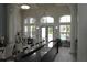 Lounge area with high ceilings, arched windows overlooking a pool, and comfortable seating at 5613 Legacy Crescent Pl # 201, Riverview, FL 33578