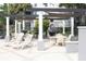 Outdoor patio area with shade coverings, fireplace, and comfortable seating perfect for relaxing at 5613 Legacy Crescent Pl # 201, Riverview, FL 33578