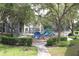Community playground with slides and climbing structures surrounded by mature trees at 5613 Legacy Crescent Pl # 201, Riverview, FL 33578