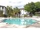 Swimming pool surrounded by patio furniture with apartment buildings in the background at 5613 Legacy Crescent Pl # 201, Riverview, FL 33578