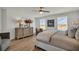Serene bedroom featuring large windows, a comfortable bed, and stylish decor at 13610 Wolfpack Rd, Hudson, FL 34667