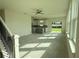 Spacious living room with abundant natural light, ceiling fan and an open-concept layout to the kitchen at 13610 Wolfpack Rd, Hudson, FL 34667