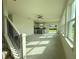 Bright living area with large windows and stairs, showcasing the transition to the kitchen at 13610 Wolfpack Rd, Hudson, FL 34667
