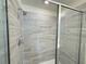 Modern walk-in shower with tiled walls and glass door, exemplifying bathroom style at 13610 Wolfpack Rd, Hudson, FL 34667