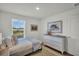 Well-lit bedroom featuring a comfortable bed, dresser, and window overlooking the water at 13622 Wolfpack Rd, Hudson, FL 34667