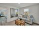 Comfortable living room with natural light, couch, decor, and a view to the outside at 13622 Wolfpack Rd, Hudson, FL 34667