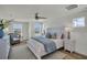 Bright main bedroom featuring a cozy chair, king bed, and a large window with a nice view at 13622 Wolfpack Rd, Hudson, FL 34667