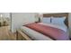 Comfortable bedroom with plush bed, accent pillows, and stylish bedside table at 13978 Emerald Fields Dr, Hudson, FL 34667