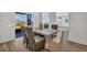 Inviting dining area with sliding glass doors, stylish table set, and views of the outdoor scenery at 13978 Emerald Fields Dr, Hudson, FL 34667