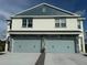 Two-story townhome featuring stone accents and two-car garages at 13978 Emerald Fields Dr, Hudson, FL 34667