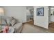 Bright hallway with wood floors, leading to upper level and bathroom at 13978 Emerald Fields Dr, Hudson, FL 34667