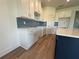 Kitchen with white cabinets, a center island with quartz countertop, and a tiled backsplash at 13978 Emerald Fields Dr, Hudson, FL 34667