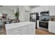 Well-equipped kitchen featuring stainless steel appliances, white cabinets, and a spacious island for meal preparation at 13978 Emerald Fields Dr, Hudson, FL 34667