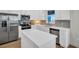Modern kitchen with stainless steel appliances, white cabinetry, ample counter space, and contemporary backsplash at 13978 Emerald Fields Dr, Hudson, FL 34667