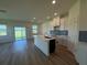 Spacious kitchen with white cabinets, center island, and open access to dining area at 13978 Emerald Fields Dr, Hudson, FL 34667
