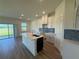 Open kitchen featuring an island, stainless steel faucet and tile backsplash at 13978 Emerald Fields Dr, Hudson, FL 34667
