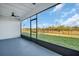Enclosed lanai with a beautiful view of the green backyard at 13978 Emerald Fields Dr, Hudson, FL 34667