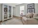 Charming living room with decorative cabinet, coastal decor, and cozy seating area at 13978 Emerald Fields Dr, Hudson, FL 34667