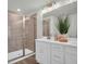 Modern bathroom with a glass-enclosed shower, double vanity, and stylish fixtures at 14004 Emerald Fields Dr, Hudson, FL 34667