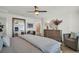 Spacious bedroom with a large bed, stylish furnishings, and a view of an ensuite bathroom at 14004 Emerald Fields Dr, Hudson, FL 34667