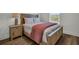 Bedroom featuring a wooden bed frame with a decorative salmon-colored throw blanket at 14004 Emerald Fields Dr, Hudson, FL 34667